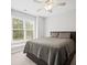 Bedroom with a ceiling fan, neutral tones, and a large window at 4320 Cody Ct, Cumming, GA 30040