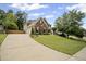 Beautiful brick home with a long driveway, manicured lawn, and mature trees in a desirable neighborhood at 4320 Cody Ct, Cumming, GA 30040