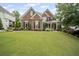 Charming two-story brick home with a well-manicured lawn, mature trees, and a welcoming front porch at 4320 Cody Ct, Cumming, GA 30040
