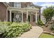 Inviting front porch with decorative plants, stylish seating, and a charming entrance at 4320 Cody Ct, Cumming, GA 30040