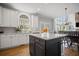 Open kitchen with island, granite countertops, stainless appliances, and a view to the living area at 4320 Cody Ct, Cumming, GA 30040