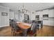 Open kitchen with white cabinets, stainless steel appliances, hardwood floors, and black island at 4320 Cody Ct, Cumming, GA 30040
