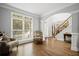 Bright and airy living room with large windows, hardwood floors, and classic furnishings at 4320 Cody Ct, Cumming, GA 30040