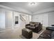 Spacious living room with neutral walls, plush carpet, and a comfortable brown leather sofa with an ottoman at 4320 Cody Ct, Cumming, GA 30040
