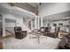 Open concept with high ceilings, the living room showcases stone fireplace and dark leather furniture at 4320 Cody Ct, Cumming, GA 30040