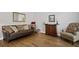 Cozy living room with hardwood floors, comfortable seating, and a vintage record player at 4320 Cody Ct, Cumming, GA 30040