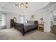 Spacious main bedroom with bed, wood floors, and large windows offering ample natural light at 4320 Cody Ct, Cumming, GA 30040