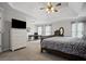 Spacious main bedroom with a sitting area, desk, ceiling fan, and ensuite at 4320 Cody Ct, Cumming, GA 30040
