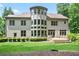 Home's backyard featuring a lush green lawn, mature trees, and spacious deck for outdoor enjoyment at 103 Millstone Way, Canton, GA 30115