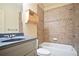 Bathroom featuring a bathtub and vanity with storage, plus a tiled backsplash at 103 Millstone Way, Canton, GA 30115