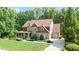 Charming brick two-story home with a covered front porch and well-manicured landscaping at 103 Millstone Way, Canton, GA 30115