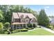 Charming brick two-story home with a covered front porch and well-manicured landscaping at 103 Millstone Way, Canton, GA 30115
