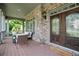 Inviting front porch with comfortable seating and a stylish double-door entry at 103 Millstone Way, Canton, GA 30115
