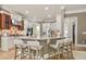 Spacious kitchen featuring an island with seating, modern stainless steel appliances and warm lighting at 103 Millstone Way, Canton, GA 30115