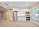 This compact kitchenette features stainless steel appliances, white cabinetry, granite countertops, and recessed lighting at 103 Millstone Way, Canton, GA 30115