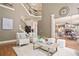 Open concept living room and entry featuring hardwood floors, staircase and view of kitchen and breakfast nook at 103 Millstone Way, Canton, GA 30115