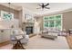 Bright living room with a cozy stone fireplace, neutral decor, and abundant natural light at 103 Millstone Way, Canton, GA 30115