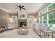 Bright living room with a cozy stone fireplace, neutral decor, and abundant natural light at 103 Millstone Way, Canton, GA 30115