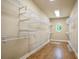 Walk-in closet with custom shelving and hardwood floors at 103 Millstone Way, Canton, GA 30115