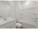 Clean and bright bathroom with a large vanity, white cabinets, and a shower-tub combo at 1204 Arnhem Dr, Hampton, GA 30228