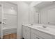 Bathroom featuring double sinks, white cabinets, and a tub with a shower head at 1204 Arnhem Dr, Hampton, GA 30228
