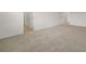 Spacious carpeted bedroom with a double door and hallway access at 1204 Arnhem Dr, Hampton, GA 30228