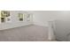 Carpeted room with three windows at 1204 Arnhem Dr, Hampton, GA 30228