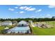 Aerial view of a community pool, clubhouse, playground, and parking area with green space at 1204 Arnhem Dr, Hampton, GA 30228