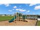 Community playground with a slide and climbing features near a pool, perfect for families at 1204 Arnhem Dr, Hampton, GA 30228