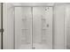 Modern glass-enclosed shower with built-in shelving and sleek fixtures at 1204 Arnhem Dr, Hampton, GA 30228