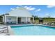 Community swimming pool with ample lounge chairs and a covered seating area at 1204 Arnhem Dr, Hampton, GA 30228