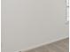 Close up on a white wall and grey carpet, partially showing a window at 1204 Arnhem Dr, Hampton, GA 30228