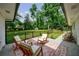 Inviting back porch features comfortable seating and serene views of the expansive, fenced backyard at 1600 Donna Sw St, Mableton, GA 30126