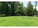 Large, flat backyard with a well-maintained lawn and mature trees at 1600 Donna Sw St, Mableton, GA 30126