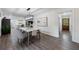Open dining room with stylish lighting, hardwood floors, and modern decor create an inviting ambiance at 1600 Donna Sw St, Mableton, GA 30126