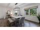 Cozy dining room with modern lighting, hardwood floors, and a view of the fenced backyard at 1600 Donna Sw St, Mableton, GA 30126