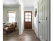 Inviting entryway features a wood door with glass and a leather chair with a cozy throw blanket at 1600 Donna Sw St, Mableton, GA 30126
