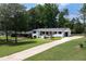 Beautifully renovated ranch home with a long driveway and manicured front lawn and flower beds at 1600 Donna Sw St, Mableton, GA 30126