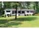 Inviting single story home featuring a white brick facade, manicured landscaping and lush front yard at 1600 Donna Sw St, Mableton, GA 30126