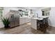 Modern kitchen features stainless steel appliances, white cabinetry, and a breakfast bar with seating at 1600 Donna Sw St, Mableton, GA 30126