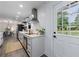 Bright, modern kitchen featuring white cabinets, stainless steel appliances, and an adjacent dining area at 1600 Donna Sw St, Mableton, GA 30126