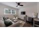 Comfortable living room featuring a sofa, desk, and a ceiling fan for relaxed living at 1600 Donna Sw St, Mableton, GA 30126