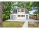 View of the backyard showcasing garage, mature trees, and well-maintained lawn at 2056 Hosea L Williams Ne Dr, Atlanta, GA 30317