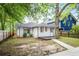 Backyard featuring a small deck, lush trees, partial fence, and a level lot at 2056 Hosea L Williams Ne Dr, Atlanta, GA 30317