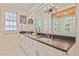 Elegant bathroom with double vanity, large mirror, contemporary lighting, and luxurious glass-enclosed shower at 2056 Hosea L Williams Ne Dr, Atlanta, GA 30317