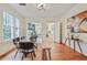 Bright dining room with hardwood floors, modern lighting, and glass top dining table at 2056 Hosea L Williams Ne Dr, Atlanta, GA 30317
