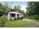 Charming bungalow with stone accents, a cozy front porch, and a lush, well-maintained lawn at 2056 Hosea L Williams Ne Dr, Atlanta, GA 30317
