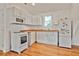 Compact kitchen features white appliances, wood countertops, and ample natural light at 2056 Hosea L Williams Ne Dr, Atlanta, GA 30317