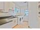 Well-equipped laundry room with washer, dryer, sink, and ample storage at 2056 Hosea L Williams Ne Dr, Atlanta, GA 30317