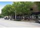 Street with businesses, outdoor seating, and mature trees, creating a vibrant atmosphere at 2056 Hosea L Williams Ne Dr, Atlanta, GA 30317